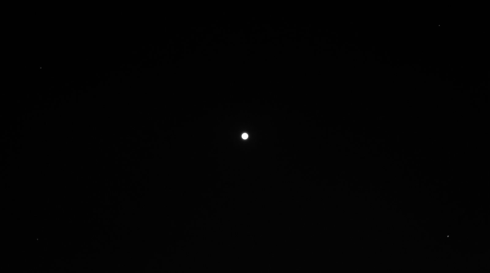 One bright pinpoint of light standing out among many faint dim points on black